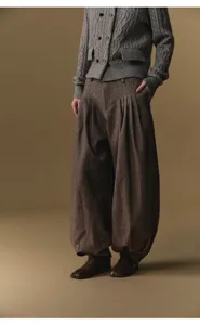 Woolen blend high-waist pleated harem pants detail showcasing stylish draping and loose fit.