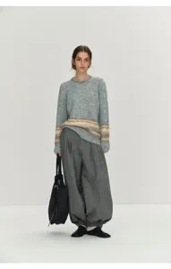 Minimalist Nordic knitwear detail, cozy Fair Isle pattern texture, elegant styling scene.