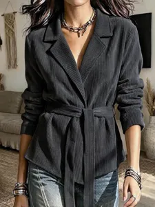 Detailed view of women's autumn corduroy belted blazer jacket showing lapel and cuff.