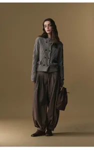 Detailed view of the stylish pleated high-waisted harem trousers in a professional look.
