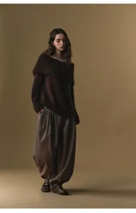 Detail view of wool blend pleated harem trousers with high waist, comfortable winter style.
