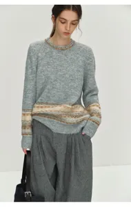 Detailed view of grey Fair Isle knit sweater with Nordic geometric patterns and long sleeves.