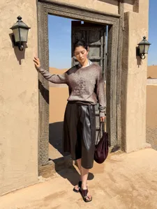 Women's gradient tie-dye crewneck lazy pullover sweater worn outdoors in desert setting.