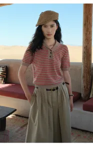 Detail view of the stylish striped knit short-sleeve top worn by the model outdoors.