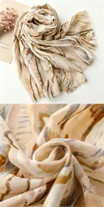 Detailed view of retro ethnic gauze scarf with abstract gold foil print and soft fabric.