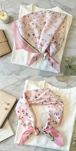 Detailed view of sweet floral square scarf, lightweight neckerchief with elegant pink pattern.
