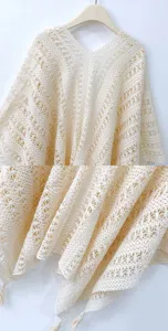 Détail de châle à franges en tricot creux beige, texture délicate et ourlet à franges.