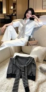 Classic black and white striped knitted shawl detail view, elegant old money fashion style.