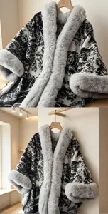 Close up detail of black and white printed cape shawl with cozy grey faux fur collar and cuffs.