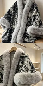 Detailed view of luxury black and white patterned knit cape with plush grey faux fur collar and cuffs.