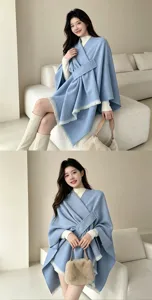 Stylish blue cape poncho for women, elegant fringe design, warm winter outer wear clothing.