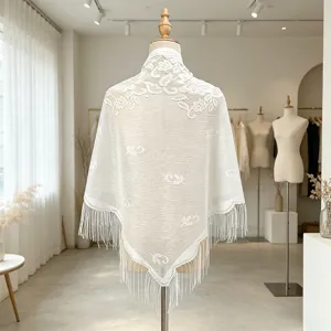 White lace hollow triangular shawl scarf with elegant floral embroidery and fringe hem for women.