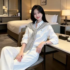 Classic old money style women white shirt with striped sweater scarf and white trousers set.