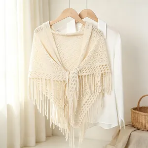 Beige hollow-out knitted tassel shawl, delicate crochet design, perfect for casual styling.