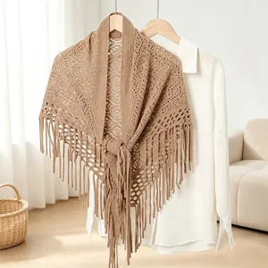 Close-up detail of the stylish brown knitted hollow fringe shawl and cardigan overlay.