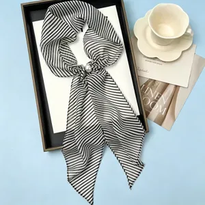 French black and white striped long silk scarf with pearl buckle, main product view flat lay.