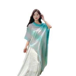 Gradient sun protection shawl for women, ethnic style beach scarf and travel photography accessory.