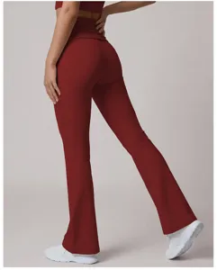 Detail view of high-waisted flare yoga pants in deep red, stretchy fit for pilates and dance.