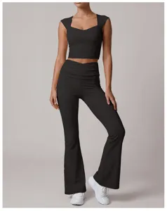 Black flared yoga pants and crop top detail shot, showing fold waist and stretchy activewear fabric.