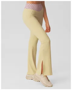 High-waisted flared yoga pants with polka dot waistband and front slit design for women.
