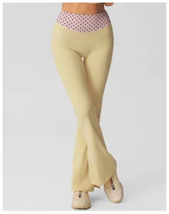 High-waisted polka dot flare yoga pants featuring a comfortable fit and stylish split hem design.