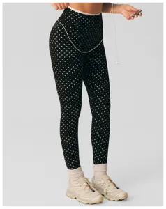 Close-up detail van zwarte en witte polkadot yoga fitness legging met hoge taillebroek.