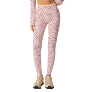Roze polkadot yoga legging en shirt met lange mouwen set voor dames fitness sportkleding.