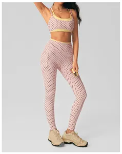 Pink polka dot yoga set detail featuring contrast yellow trim, stylish gym activewear.