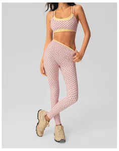 Pink polka dot crossover yoga set detail showing textured fabric, contrast trim and premium fit.
