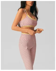 Pink polka dot yoga set with sports bra and high waist leggings for fitness workout.