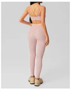 Pink polka dot yoga set with contrasting straps, high waist fitness leggings and bra.