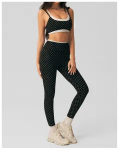 Stylish black and white polka dot yoga set featuring sports bra and leggings for fitness.