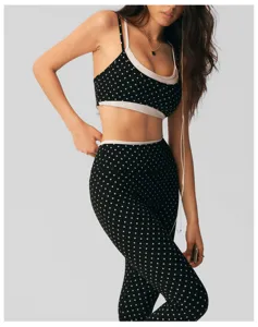 Detailed view of the black and white polka dot yoga set, featuring a fake two-piece bra and leggings.