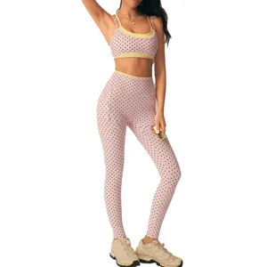 Pink polka dot yoga set with sports bra and high-waisted leggings for gym fitness workouts.