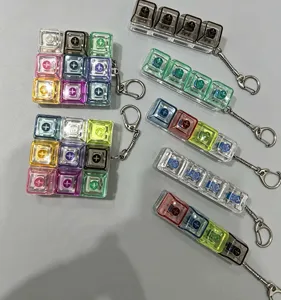 Transparent mechanical keyboard keycap keychain fidget toy set, multi-color stress relief accessory.