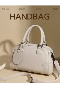 Elegant women's leather Boston handbag with top handles and shoulder strap for daily commuting.