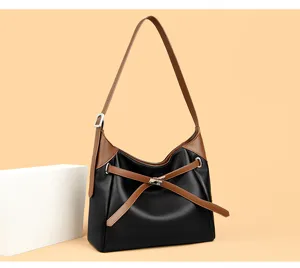 Detailed view of the elegant black and brown PU leather hobo shoulder bag with strap.