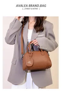 Stylish brown leather Boston handbag for women, versatile shoulder and crossbody commute bag.