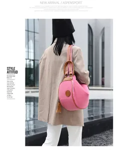 Stylish canvas backpack for women, durable daily shoulder bag featuring brown leather trim.
