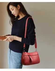 Red soft leather shoulder bag for women, stylish crossbody bag with crocodile pattern and strap.