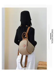 Back view detail of stylish canvas backpack with leather trim, ring handle and casual look