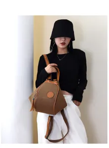 Canvas multi-functional women backpack shoulder bag detail view with stylish tassel accent