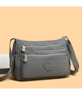 Grey nylon multi-pocket crossbody shoulder bag, detailed view showing zipper compartments.