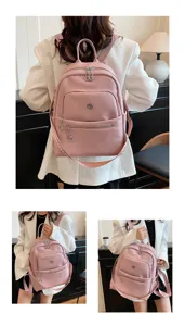 Detailed view of women pink casual backpack, showing leather texture and double shoulder straps.