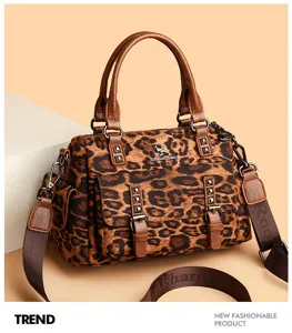 Retro leopard print crossbody handbag detail with metal studs and brown leather straps.