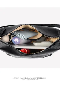 Detailed view of the black leather shoulder bag interior capacity showing organized daily essentials.