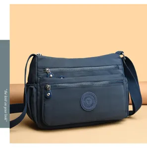 Casual nylon multi-pocket crossbody bag detail, durable fabric and multiple zippers for daily use.