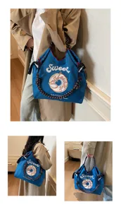 Detail view of Japanese embroidered nylon tote bag, casual shoulder handbag with donut design.