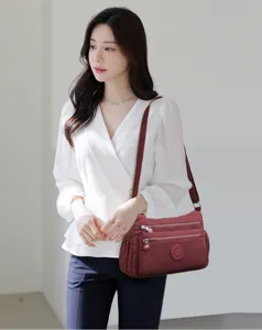 Wine red nylon crossbody bag with multi pockets worn by model, casual style daily use.