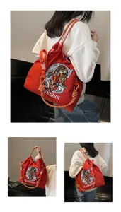 Detailed view of the stylish canvas shoulder bag featuring intricate embroidery and straps.